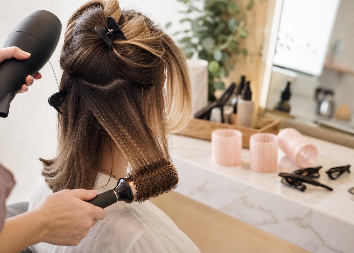 Round brush tutorial for a medium length blowout with rollers and section clips